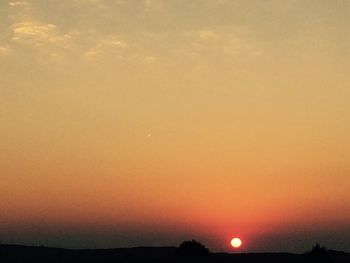 Scenic view of silhouette landscape against romantic sky at sunset