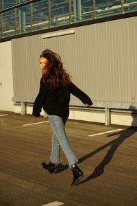 Full length of woman walking on street