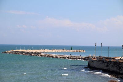 The pier of san nicola with the green lighthouse