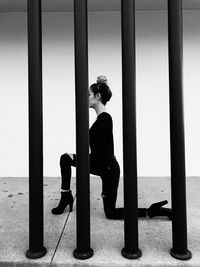 Side view of young woman sitting on seat