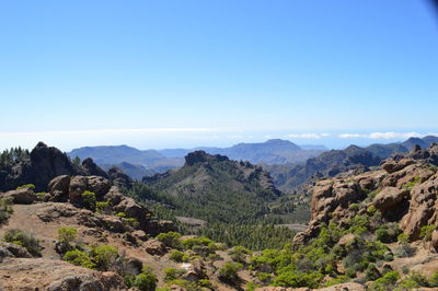 Scenic view of mountains against clear blue sky