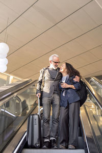 Mature couple on escalator