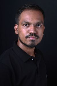 Portrait of man against black background