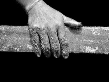 Close-up of hand against black background