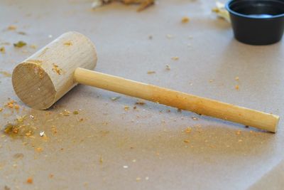 Close-up of wooden hammer on table