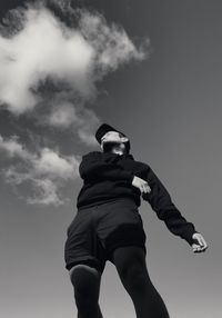 Low angle view of man standing against sky