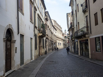 Narrow street amidst buildings in city