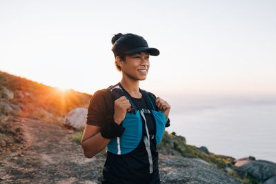 Female athlete standing on mountain