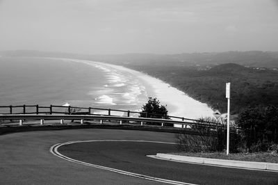 Road by bridge against sky