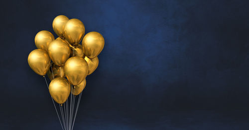 Close-up of heart shaped balloons against black background