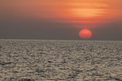 Scenic view of sea against orange sky