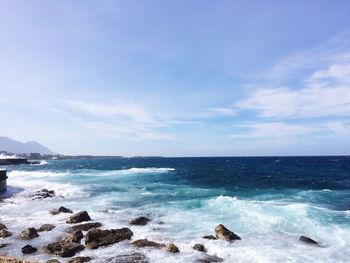 Scenic view of sea against blue sky