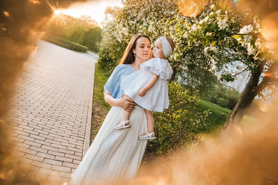 Portrait of young woman standing in park
