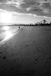 Silhouette man at beach during sunny day