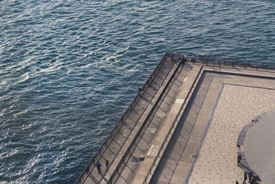 High angle view of people on bridge over sea