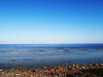 Scenic view of sea against clear blue sky