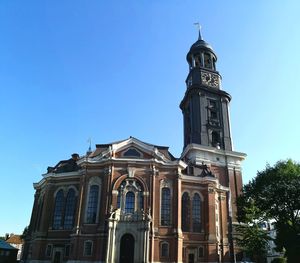 Low angle view of building against clear blue sky