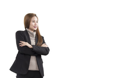 Portrait of young woman against white background