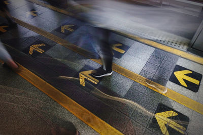 Low section of person walking on staircase