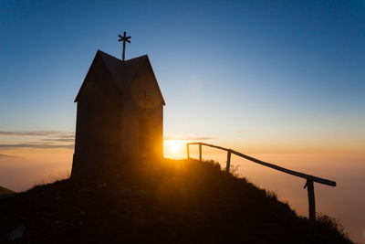 Low angle view of silhouette building against sky during sunset