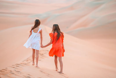 Rear view of women walking on road