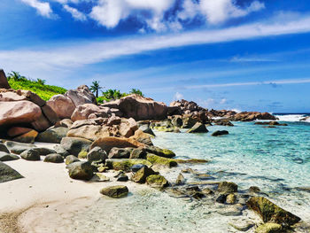 Rocks on beach against sky