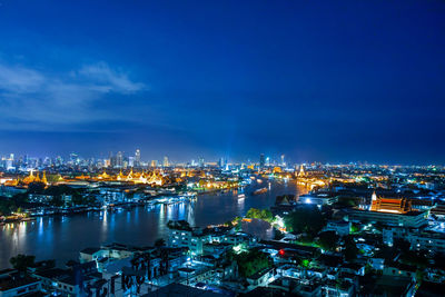 High angle view of illuminated buildings against sky at night