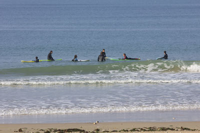 People on beach against sky