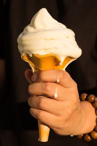 Close-up of hand holding ice cream cone