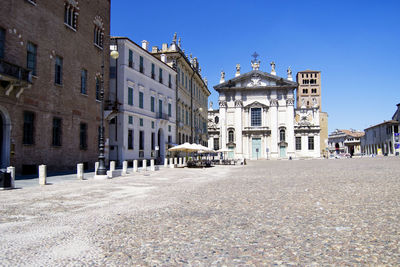 Buildings in city against blue sky