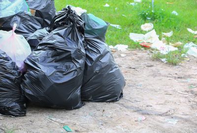 Close-up of garbage bags on sand