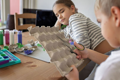 Side view of boy playing chess