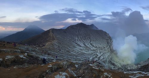 Smoke emitting from volcanic mountain against sky