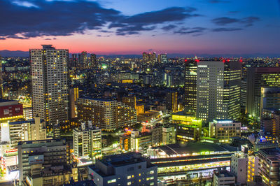 High angle view of illuminated buildings in city at night