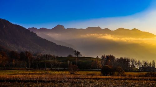 Scenic view of field against sky during sunset