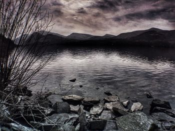 Scenic view of lake against cloudy sky