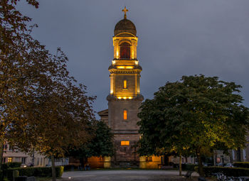 Low angle view of illuminated building against sky