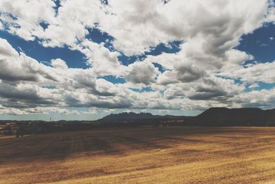 Scenic view of landscape against cloudy sky