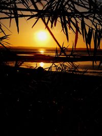 Scenic view of sea against orange sky