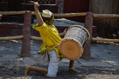 Rear view of boy with umbrella