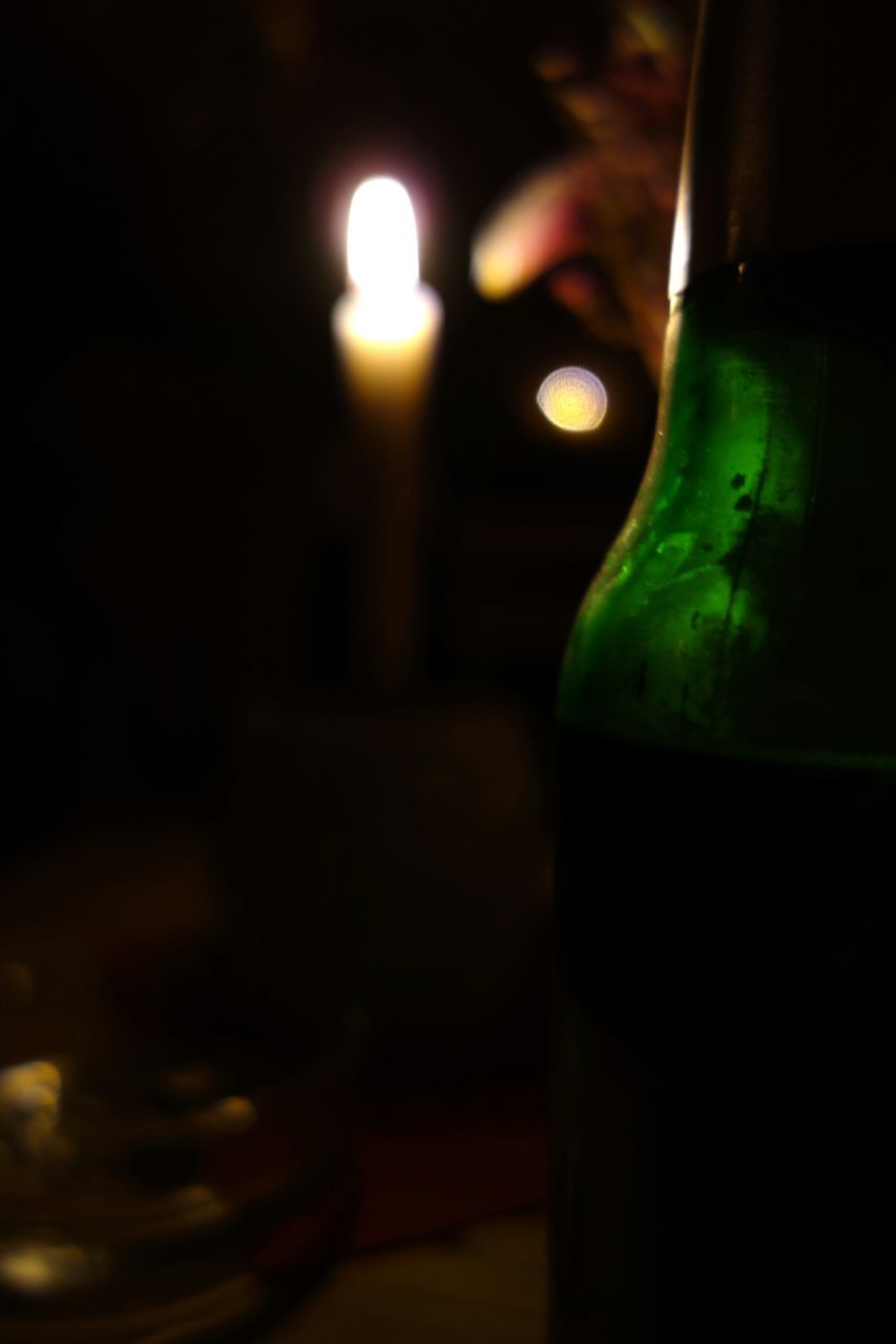 indoors, close-up, illuminated, still life, drink, focus on foreground, selective focus, table, candle, night, no people, food and drink, bottle, glowing, drinking glass, dark, light - natural phenomenon, glass - material, alcohol, green color