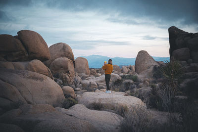 A woman with a baby is standing in a desert of california