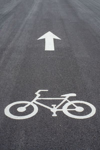 High angle view of bicycle sign on road in city