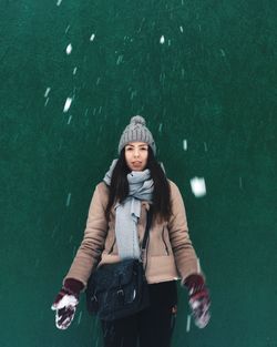 Portrait of young woman in rain