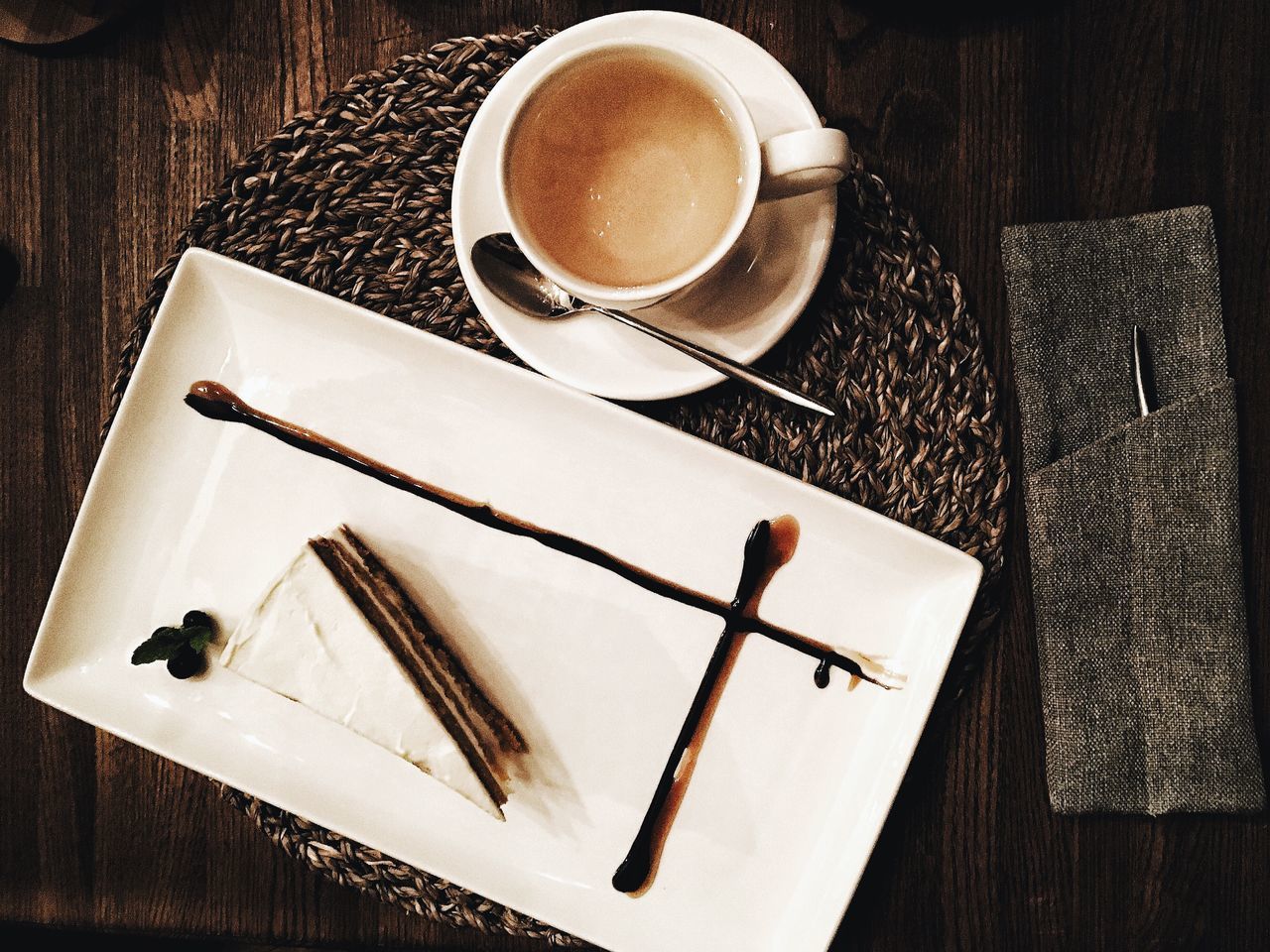 HIGH ANGLE VIEW OF COFFEE CUP AND SPOON ON TABLE