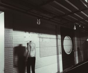 Man and woman walking in illuminated corridor