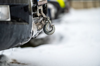 Winch with hook in 4x4 off-road car front bumper, closeup