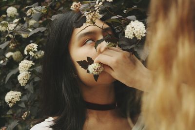 Close-up of woman with flowers