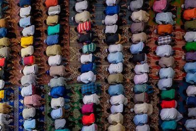 High angle view of people praying in mosque