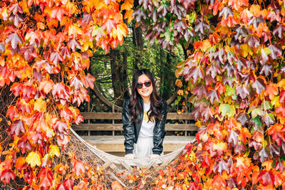 Portrait of smiling young woman during autumn